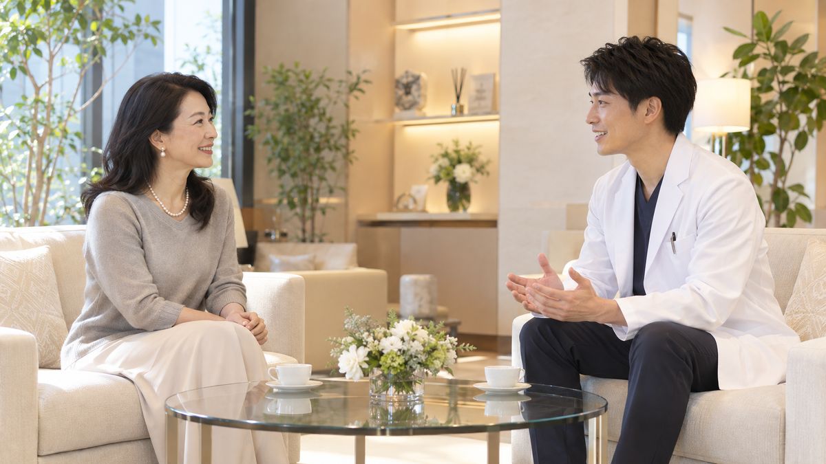 相談ラウンジのソファで向き合って話す女性と男性医師